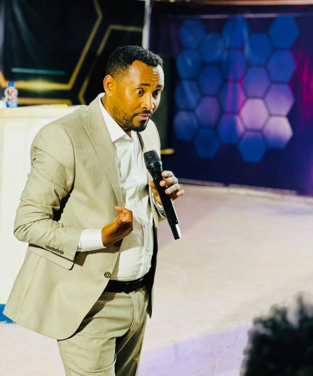 Evangelist Hailu Lemma speaking into a microphone